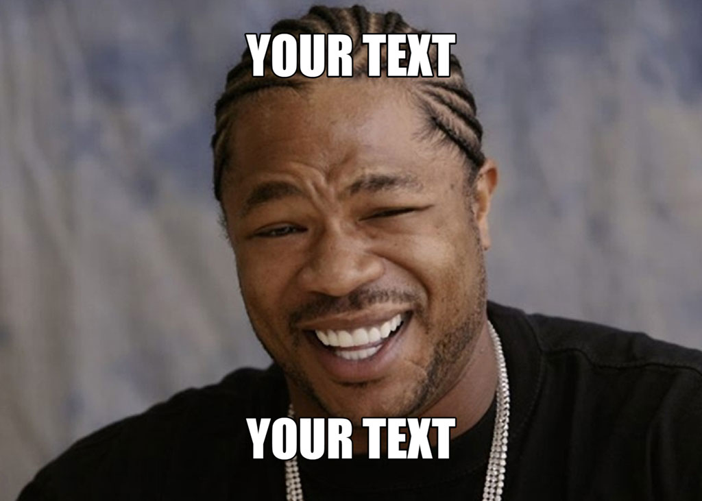 A man with braided hair laughing, wearing a black shirt and silver chain.