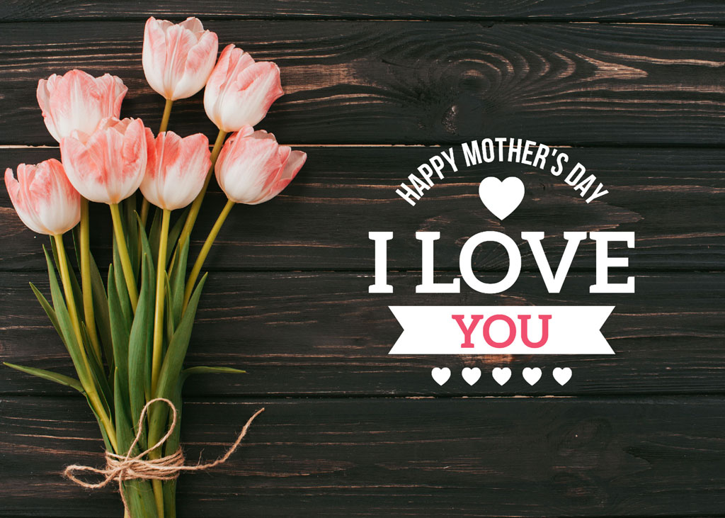 Bouquet of pink tulips on a wooden background with Happy Mother's Day message