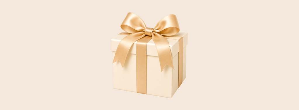 Wrapped gift box with a gold ribbon on a soft beige background.
