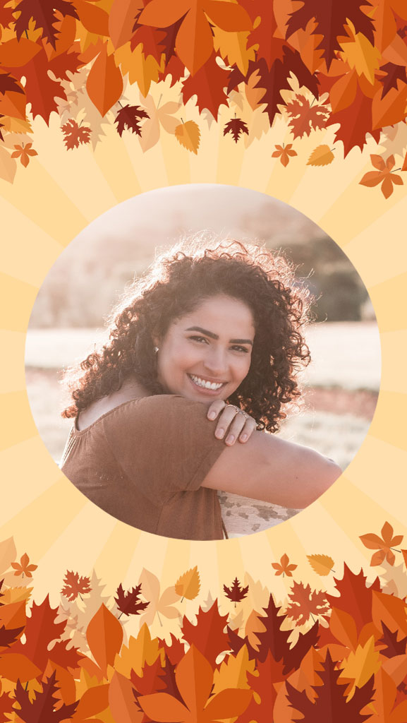 A young woman smiling with curly hair