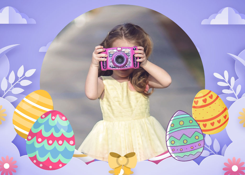 Young girl in yellow dress holding a pink camera amidst Easter eggs