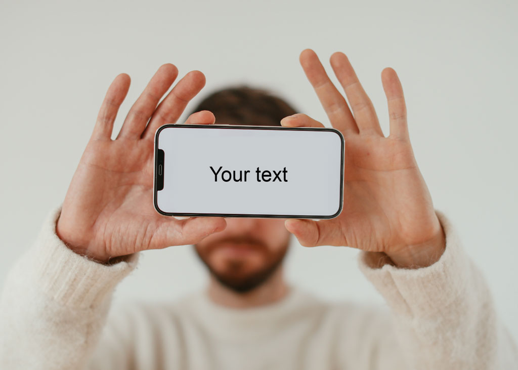 Man holding a smartphone with blank screen