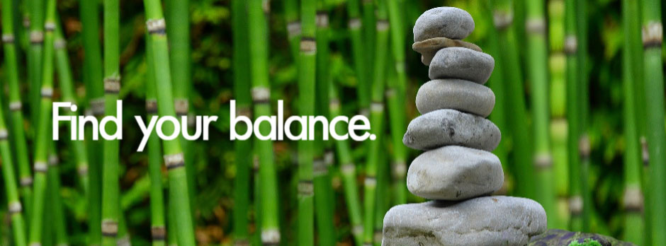 Stacked stones in front of bamboo plants with the text 'Find your balance.'