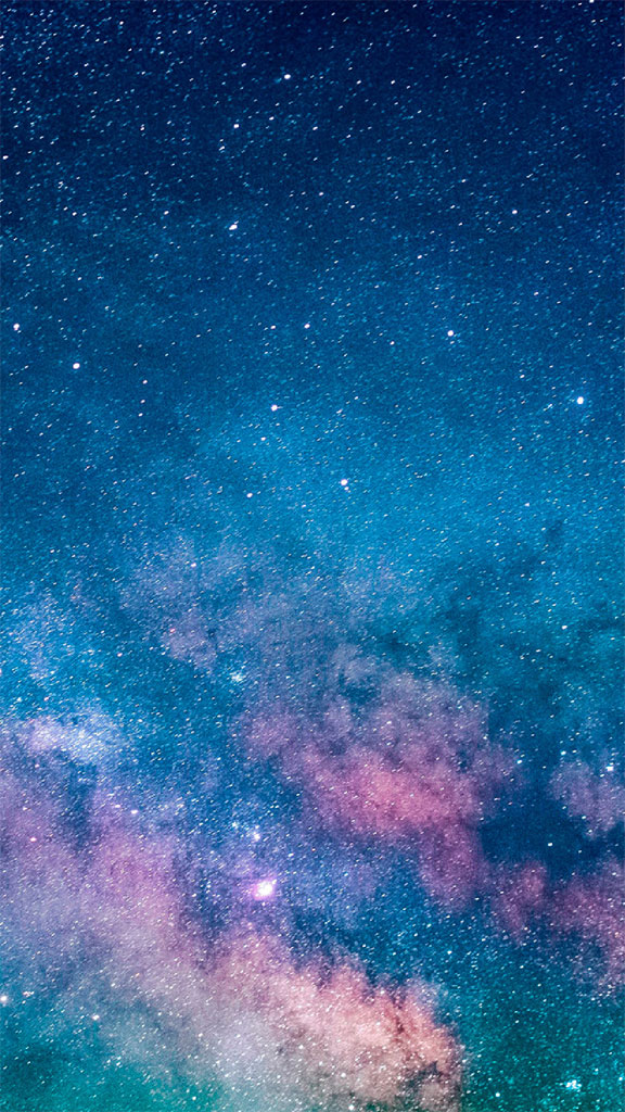 A colorful galaxy in the night sky filled with stars.