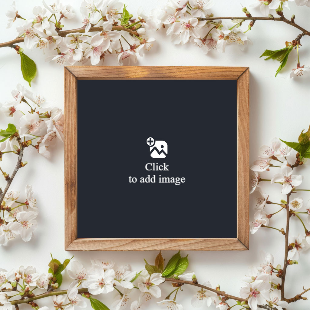 A blank chalkboard with a wooden frame surrounded by white flowers and green leaves.