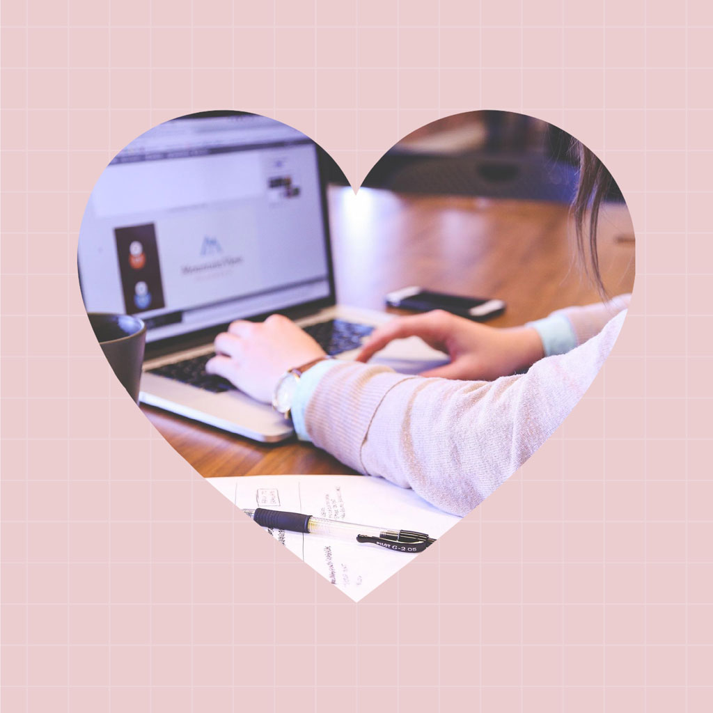 Person working on laptop with heart-shaped overlay