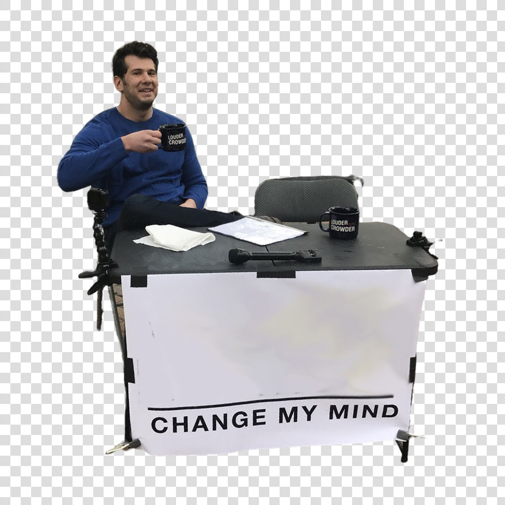 Man sitting at a desk with a Change My Mind sign and podcasting gear