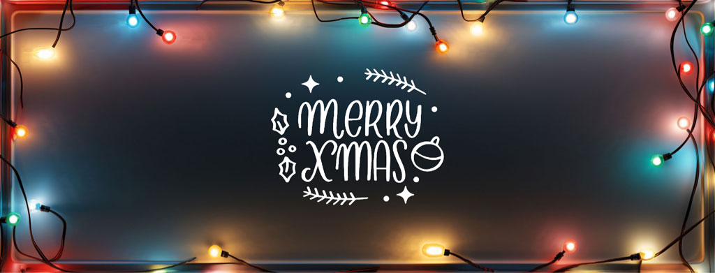 Merry Christmas written in white on a dark background surrounded by multicolored string lights