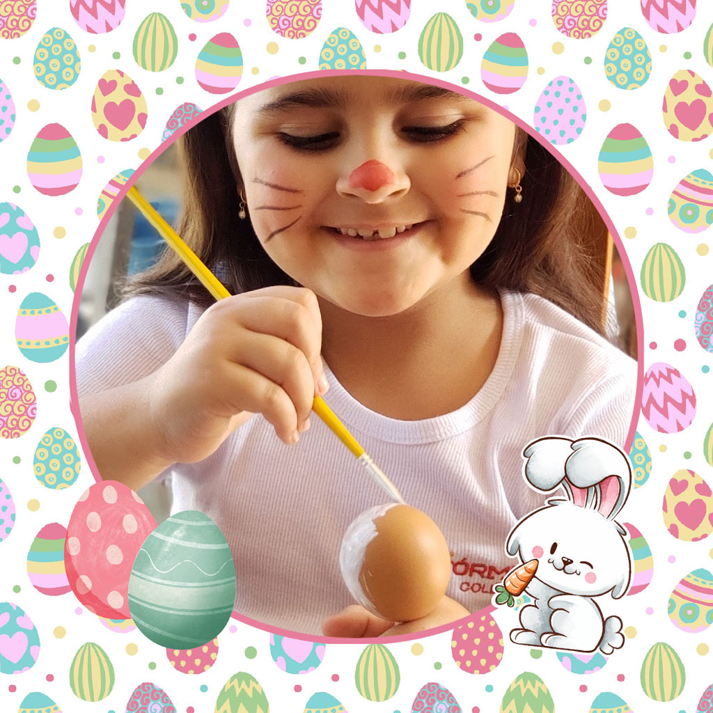 Young girl decorating Easter eggs with a paintbrush