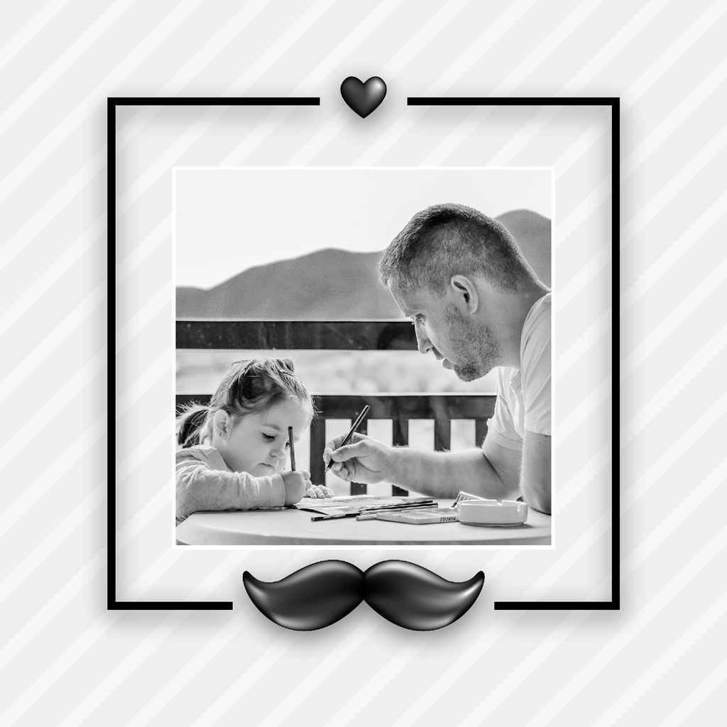 Black and white photo of a father and daughter drawing together