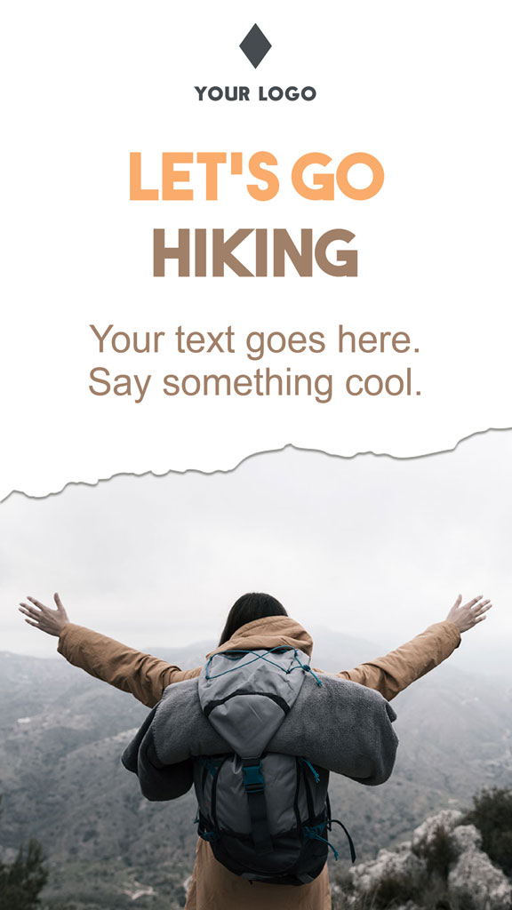 Person with arms outstretched on a mountain peak