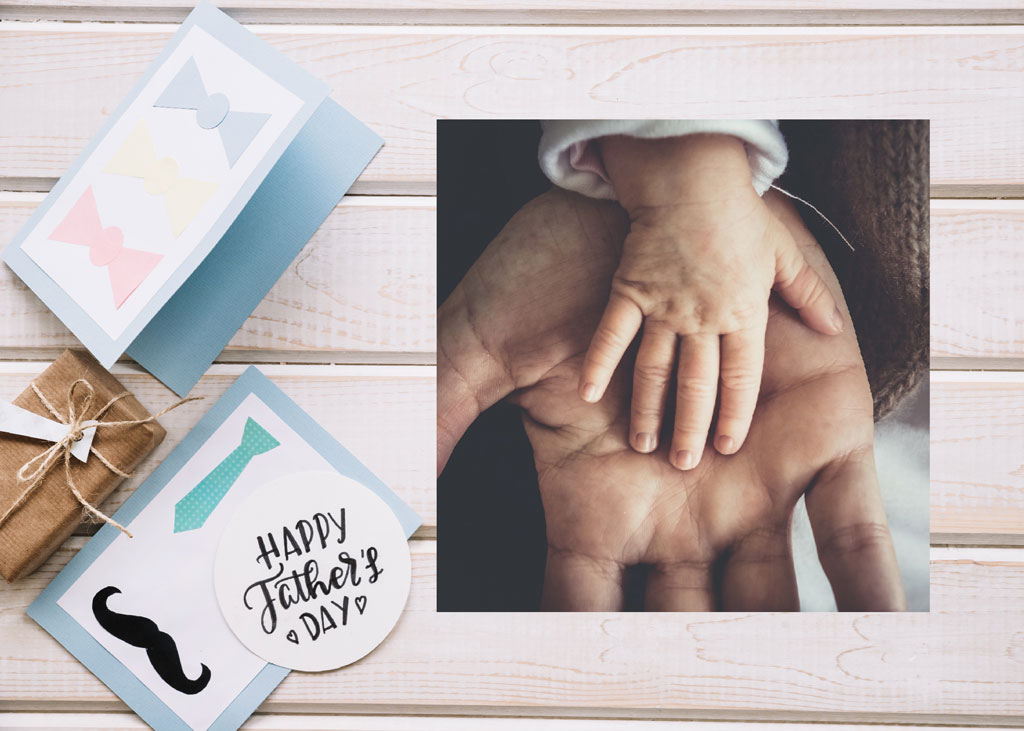 Father's Day card and gift with a child's hand on an adult's hand
