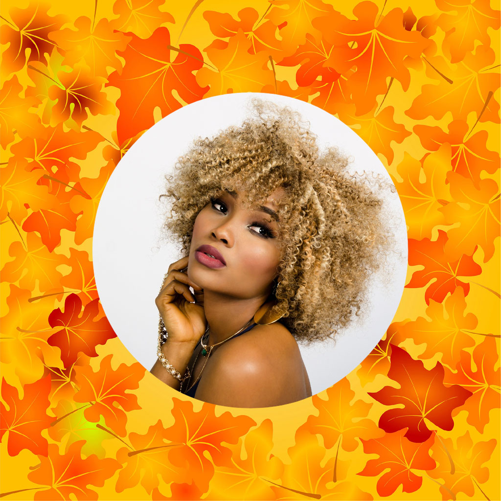 Woman with curly blonde hair and autumn leaves background