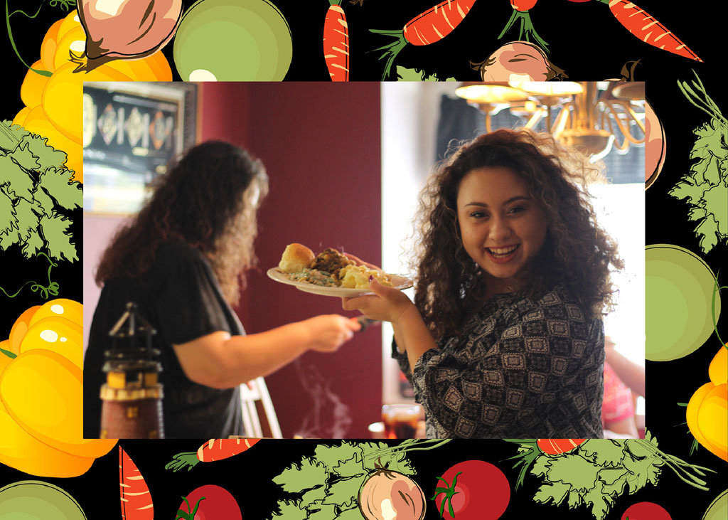 Woman receiving a plate of food from another woman in a restaurant.
