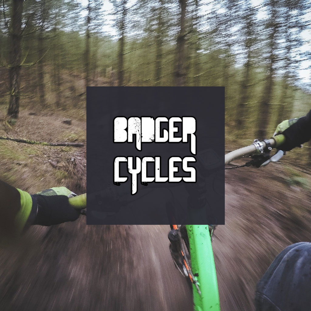 Person riding a green mountain bike through a forest trail