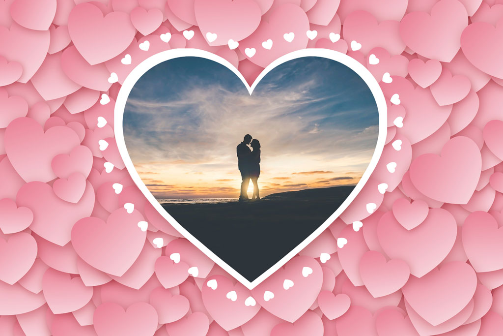 Couple kissing at sunset within a heart-shaped frame