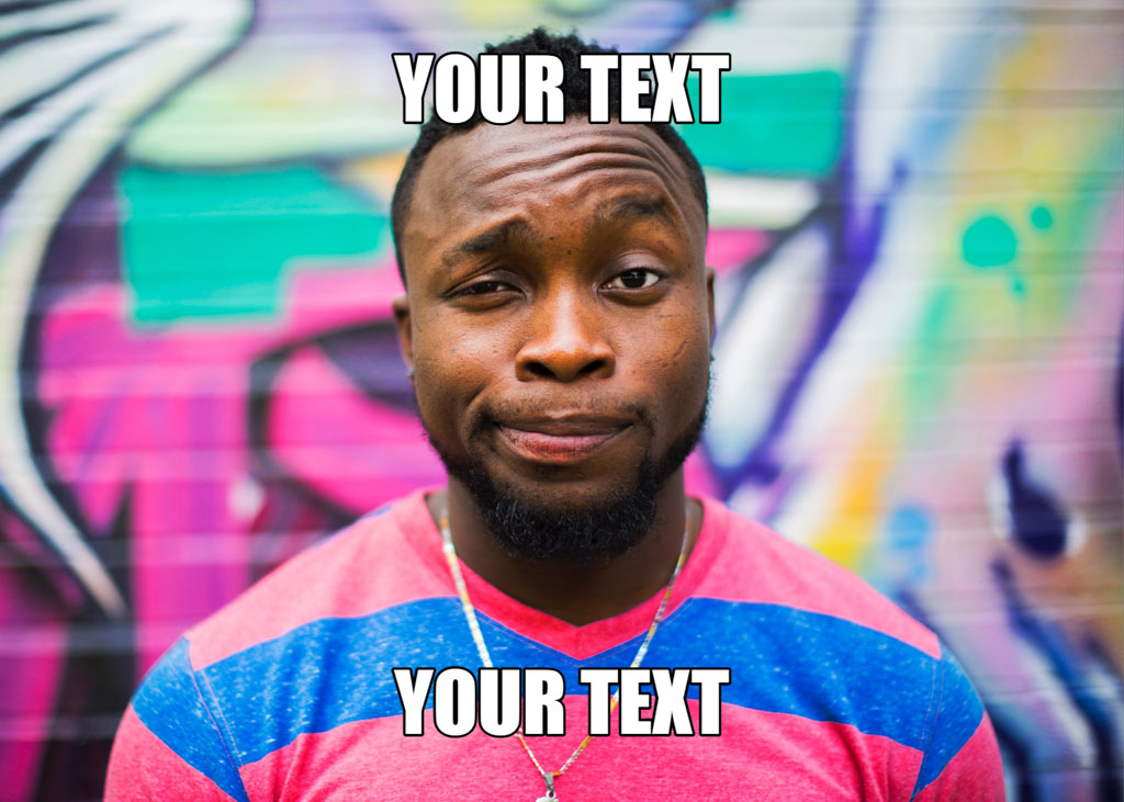 Man standing in front of a colorful graffiti wall