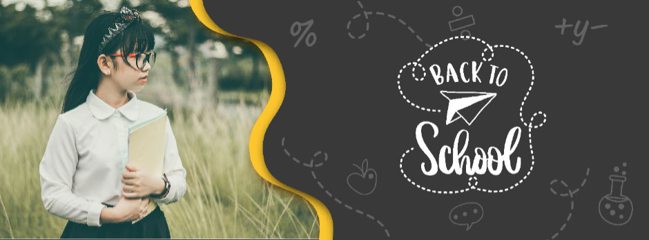 Young student holding books in a field