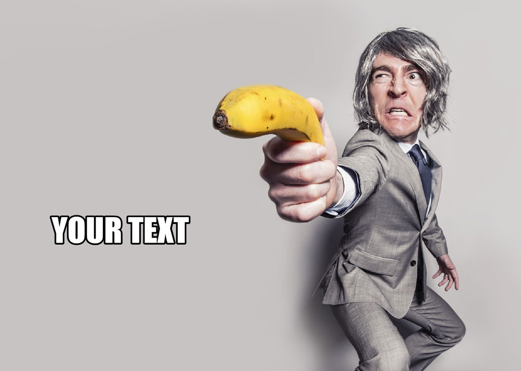 Man in gray suit holding a yellow banana
