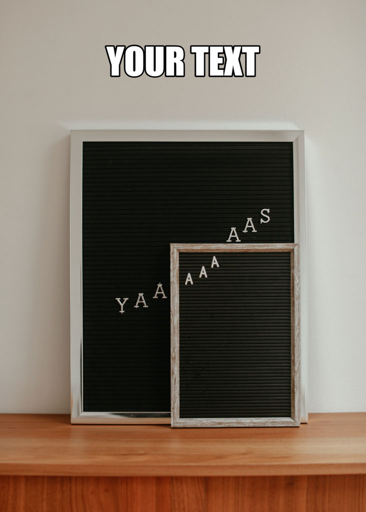 Two black letter boards with white letters on a wooden shelf