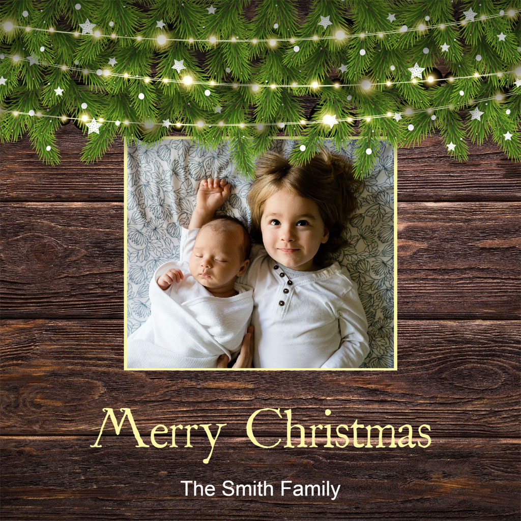 Two children lying on a blanket, surrounded by Christmas decorations