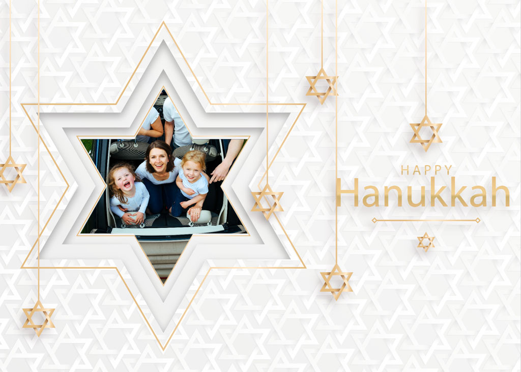 A Hanukkah greeting card with a family photo inside a Star of David