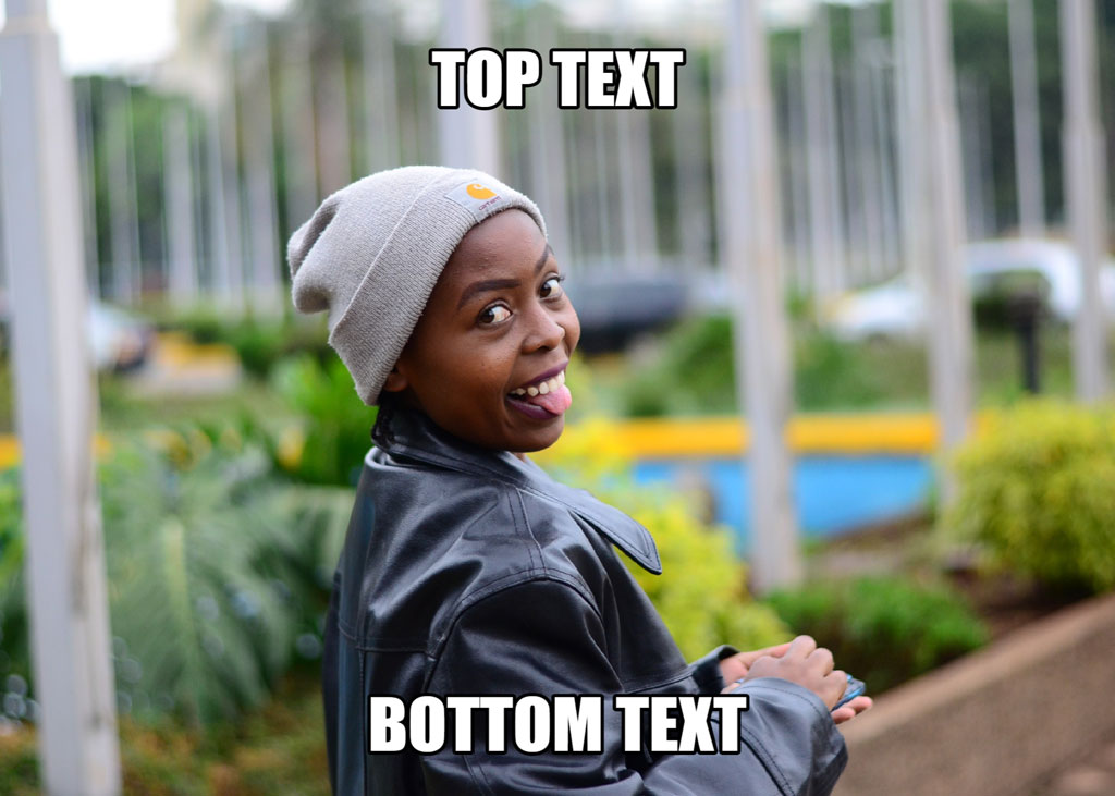 A young boy in a beanie and leather jacket making a funny face.