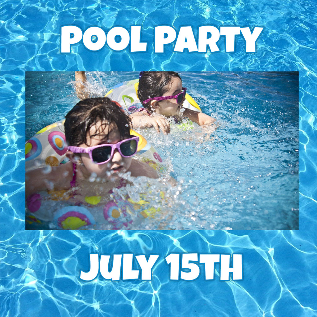 Two young girls swimming in a pool with goggles on