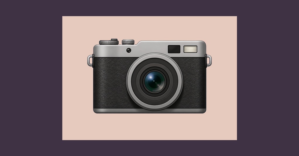 A vintage camera centered on a soft pink background with dark framing.