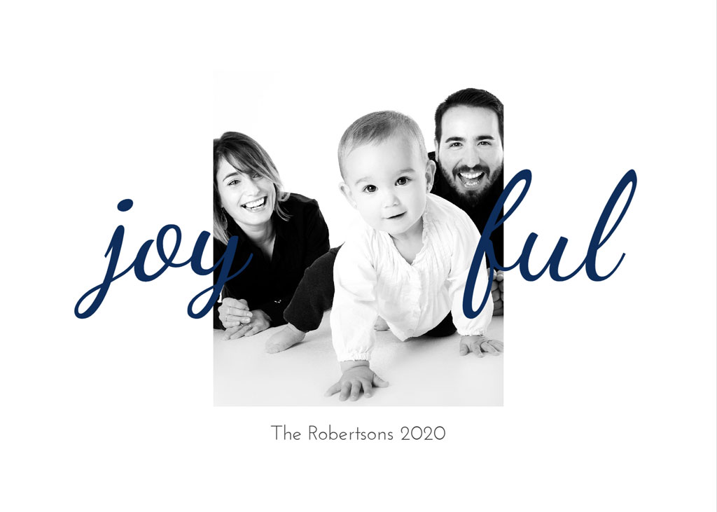 Black and white photo of a smiling family with a baby on all fours, surrounded by the word 'joyful'