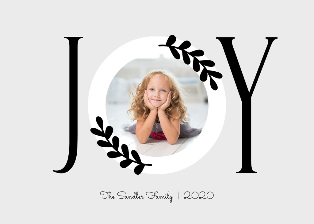 Young girl with curly hair smiling in a circular frame with 'JOY' text