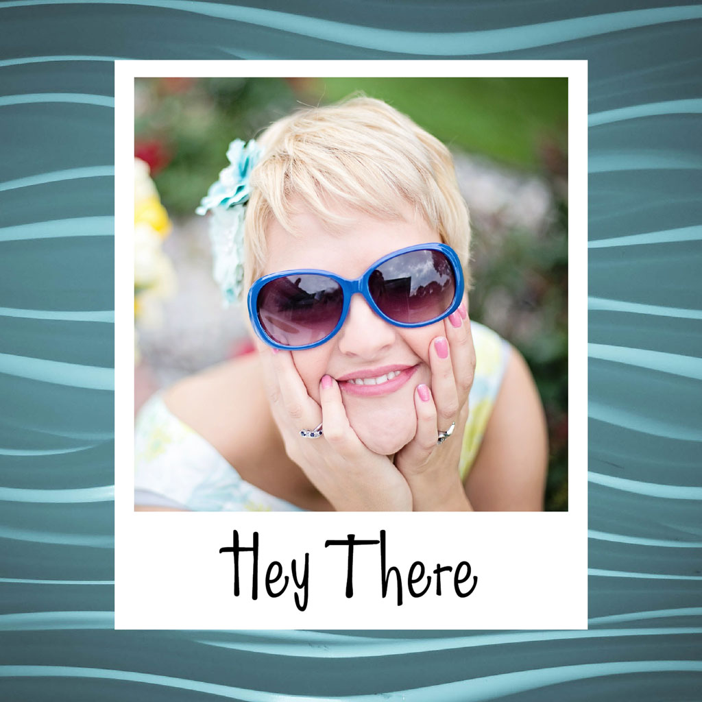 A smiling woman with short blonde hair and blue sunglasses