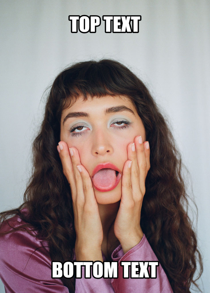 A young woman with long brown hair and colorful eye makeup, looking surprised with hands on her face and tongue out.