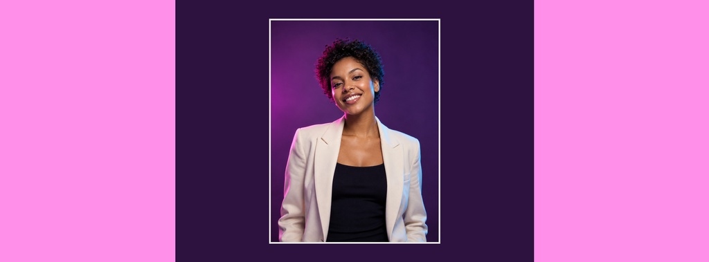 Smiling woman in a light blazer framed by a purple portrait panel on a pink background.
