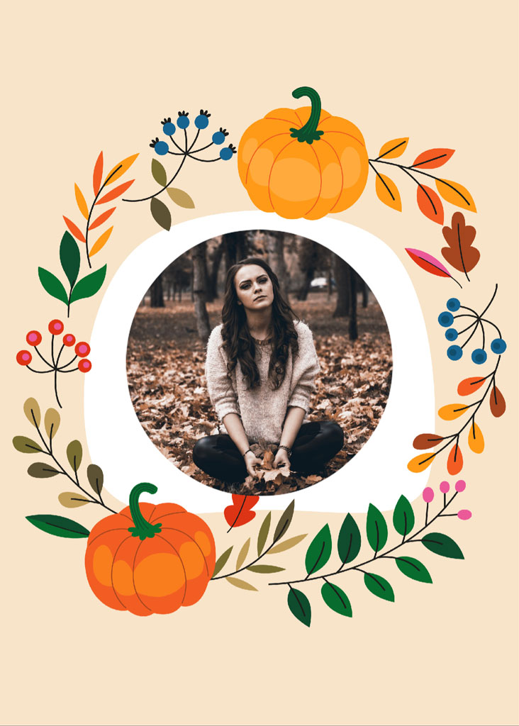 Woman sitting in leaves with pumpkins and foliage around her