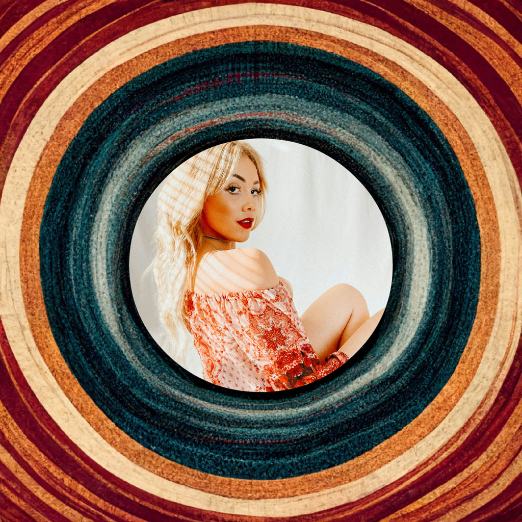 Blonde woman in red floral dress within a circular frame
