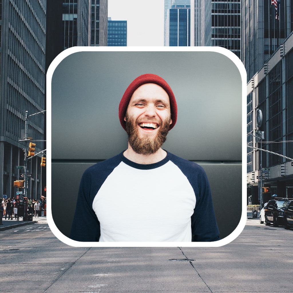 Smiling man with red beanie on city street
