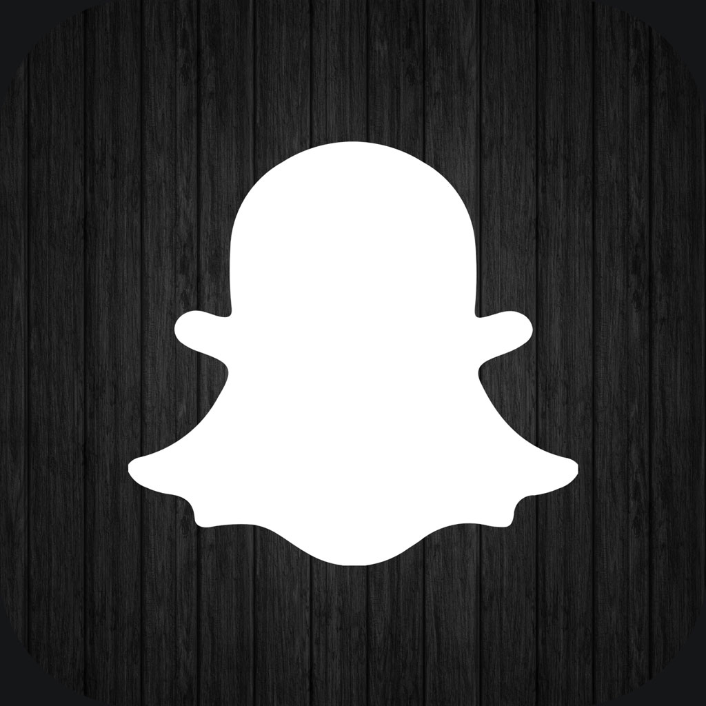 Snapchat logo on a dark wooden background