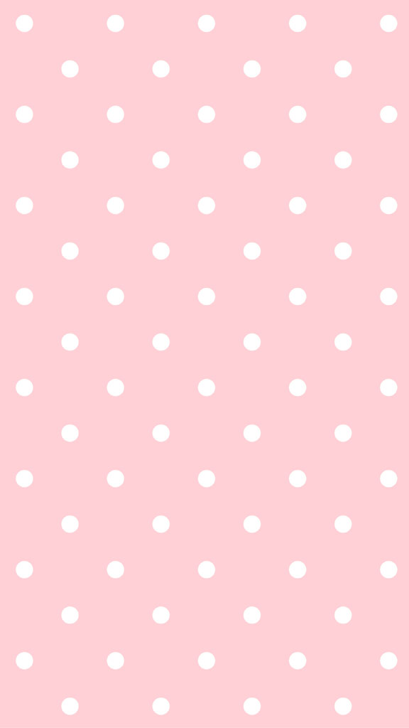 A pink background with evenly spaced white polka dots.