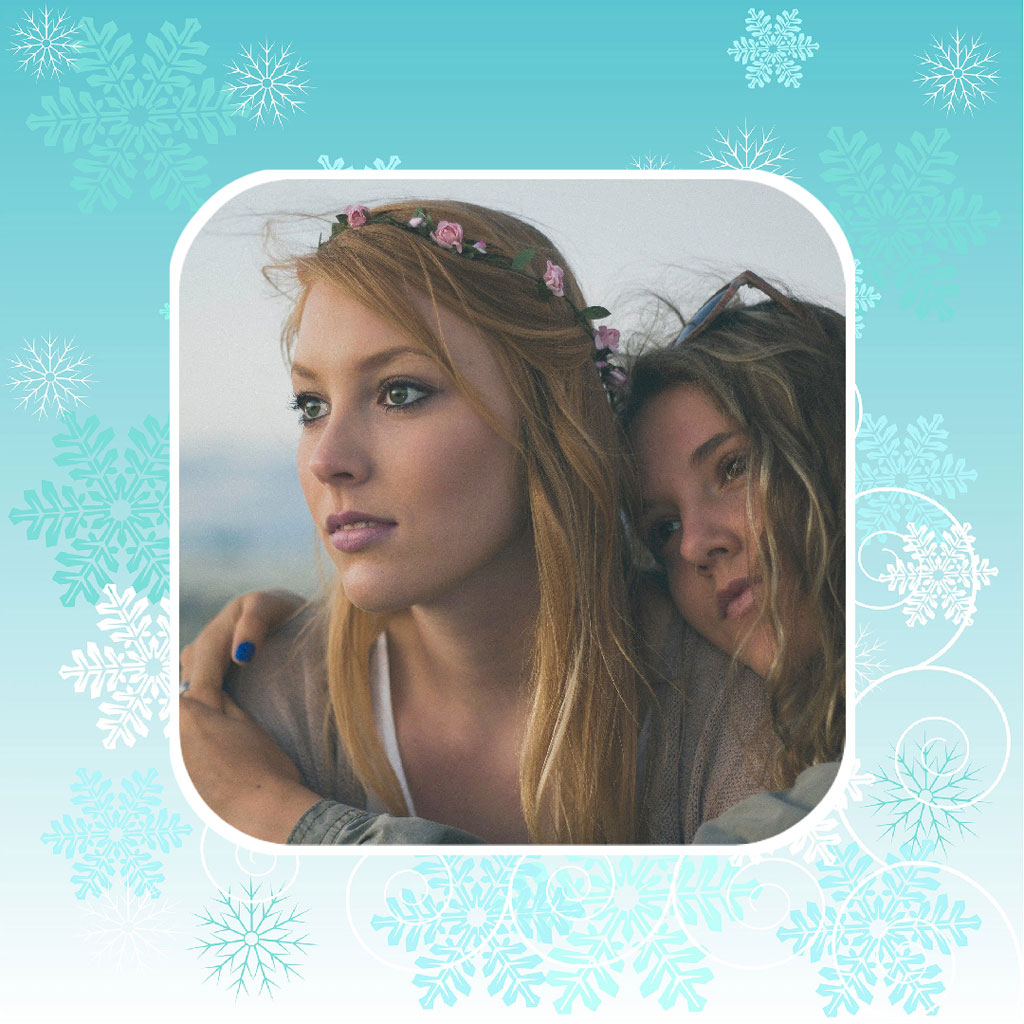 A blonde woman with a floral headband and a brunette woman embracing, looking away from the camera.