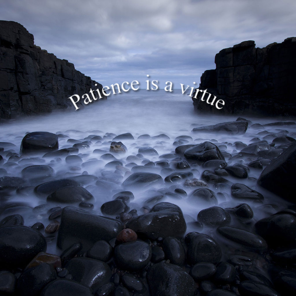 Rocky beach with 'Patience is a Virtue' text overlay