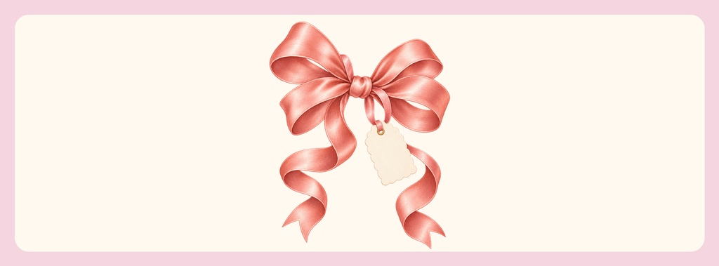Pink satin bow with curling ribbons and a hanging tag on a pale background.