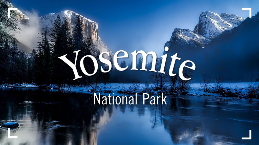 Yosemite National Park landscape with snow-capped mountains and a calm lake