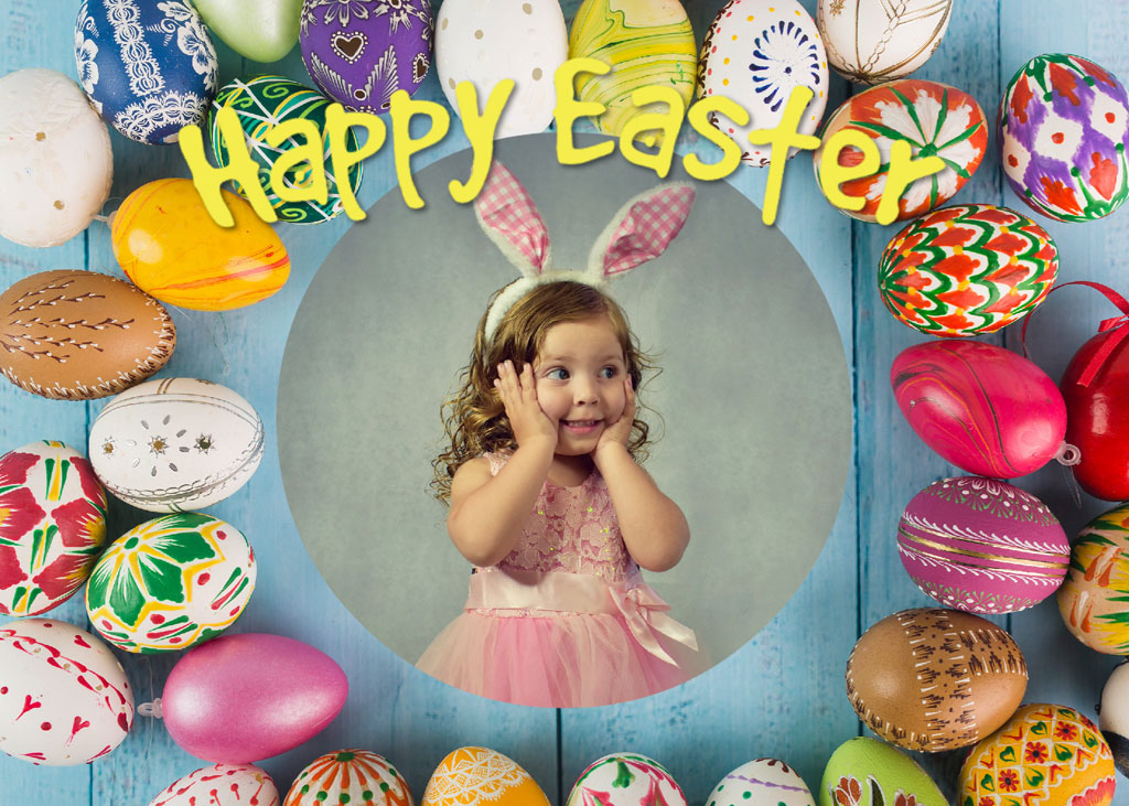 Little girl in pink dress wearing bunny ears surrounded by Easter eggs