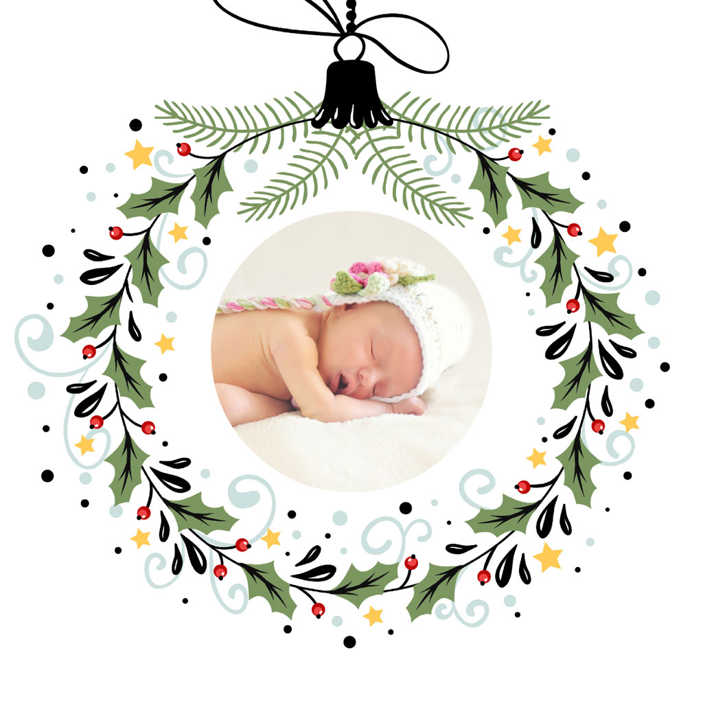 Christmas ornament with a sleeping baby inside a wreath