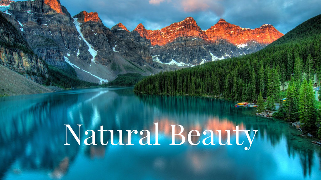 A tranquil lake reflecting majestic mountains and evergreen trees