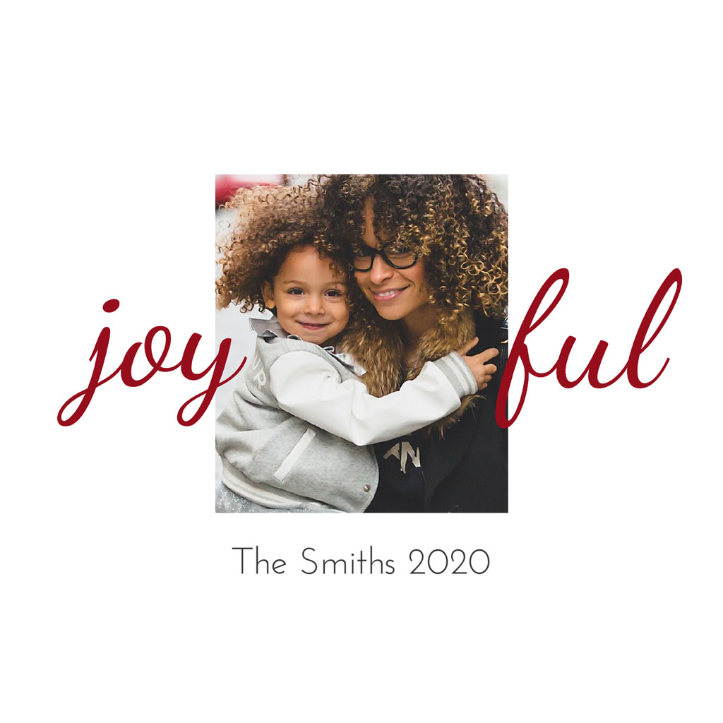 Mother hugging child with curly hair, smiling together