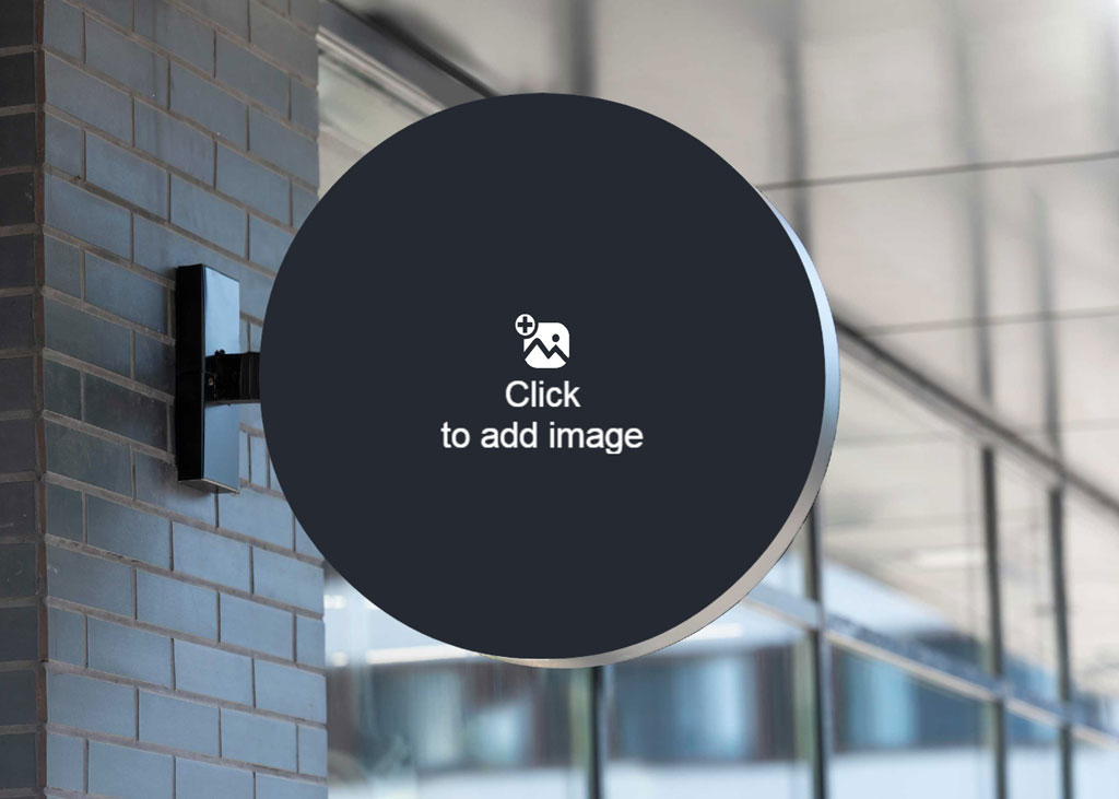 A modern round sign mounted on a brick wall