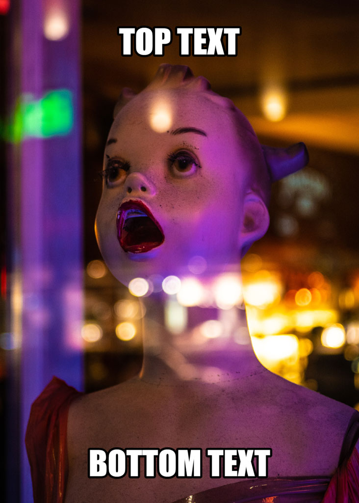 A doll with an open mouth and blurred background, overlaid with 'TOP TEXT' and 'BOTTOM TEXT'