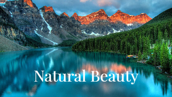 A tranquil lake reflecting the surrounding mountains and trees.